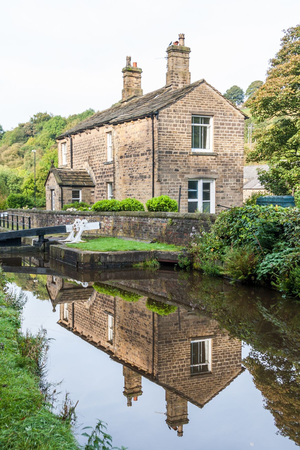 House reflected in the water, Huddersfield narrow canal, Diggle, Saddleworth, Oldham, England, United Kingdom
